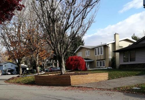 Landscape work placing a garden box in front and replacing front lawn with new turf. - 74 Ave  (After)